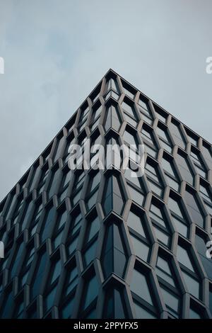 Fenêtres hexagonales sur un gratte-ciel, verre hexagonal bleu, grand bâtiment, bloc tour d'architecture, appartements bâtiments urbains Banque D'Images