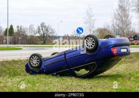 Scène d'accident de voiture, une voiture de tourisme a quitté la route et renversé à l'envers, voiture renversée Banque D'Images