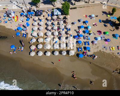 Vue aérienne d'une plage animée dans la station balnéaire populaire de Nea Chora à Chania, Crète (Grèce) Banque D'Images