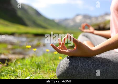 Gros plan d'une femme mains faisant du yoga dans la nature Banque D'Images