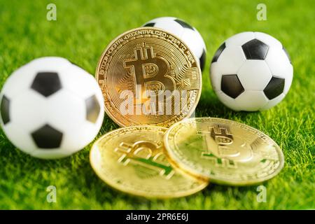 Bitcoin d'or avec ballon de football ou de football, crypto-monnaie utilisée dans les Paris sportifs en ligne. Banque D'Images