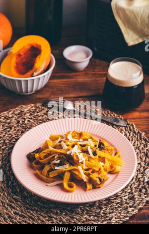 Tagliatelle pâtes avec sauce crémeuse à la citrouille et champignons Banque D'Images