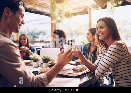 Nous sommes d'accord sur une chose, un excellent café. Prise de vue d'amis avec une tasse de café pendant le déjeuner. Banque D'Images