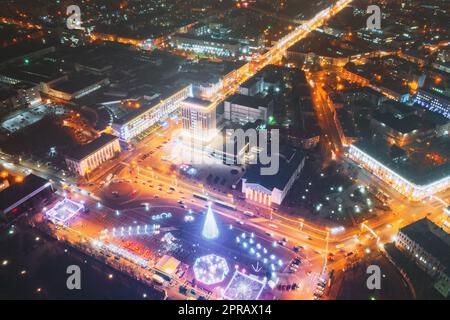 Gomel, Bélarus. Arbre de Noël principal et illumination festive sur la place Lénine à Homel. Nouvelle année en Biélorussie. Vue aérienne de nuit Banque D'Images