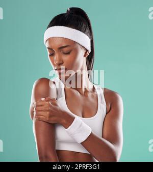 Joueur de tennis blessé, blessé ou douleur dans son bras après l'entraînement sur fond vert de studio. Athlète professionnelle de sexe féminin souffrant de tension musculaire, d'accident et d'inflammation sur son corps Banque D'Images