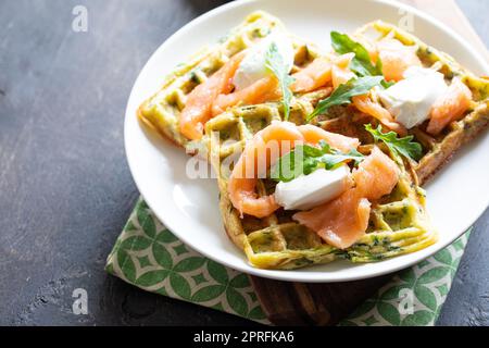 Gaufres belges avec courgettes et légumes verts, fromage cottage et saumon salé. Banque D'Images