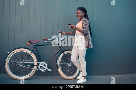 Petite fille, détendez-vous avec un vélo et en utilisant l'application pour smartphone, les médias sociaux et en effectuant une recherche sur Internet ou sur le Web. L'élève utilise son vélo pour la santé, l'entraînement amusant ou le voyage en vélo à l'école, à l'université ou à l'université Banque D'Images