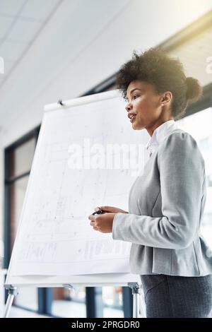 Jeune, brillant et responsable. Une jeune femme d'affaires qui donne une présentation. Banque D'Images