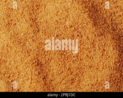 Texture de fond du sucre de noix de coco biologique cru de la sève cristallisée des boutons de fleurs coupées de la noix de coco. Fond de sucre de noix de coco brun topview. Al Banque D'Images