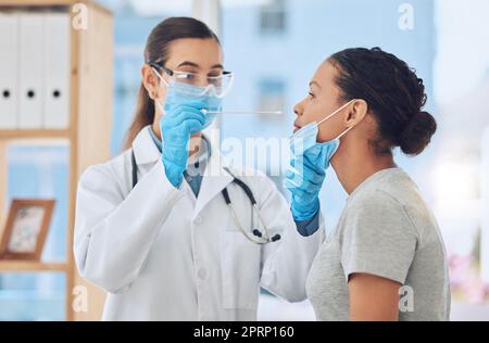 Médecin effectuant un test covid sur le patient en prenant un échantillon avec un écouvillon nasal dans son bureau. Une travailleuse de la santé et une femme ayant un masque facial en consultation clinique pendant une pandémie de coronavirus à l'hôpital Banque D'Images