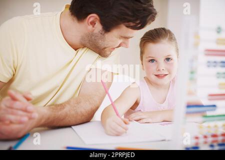 Elle fait toujours ses devoirs. Une petite fille fait ses devoirs. Banque D'Images