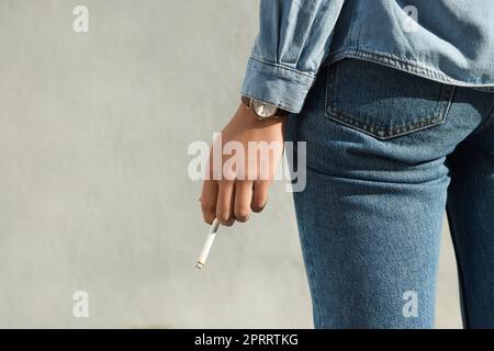 Femme avec cigarette à l'extérieur, gros plan. Espace pour le texte Banque D'Images