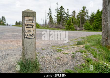 Panneaux en pierre dans le parc national de Harz avec des indications pour Torfhaus, Ilsenburg, chutes d'eau d'Ilse, et le sommet de Brocken. Banque D'Images