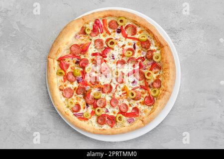 Vue de dessus d'une petite pizza avec saucisse fine, poivron, olives Banque D'Images