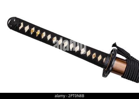 Tsuka - handle of Japanese sword wrapped by black silk cord on white ray skin isolated in white background. Selective focus. Stock Photo