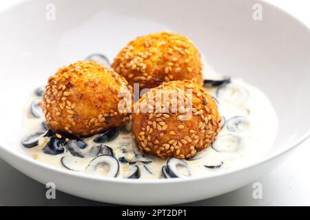 boules de pois chiches à la sauce crémeuse aux olives noires Banque D'Images