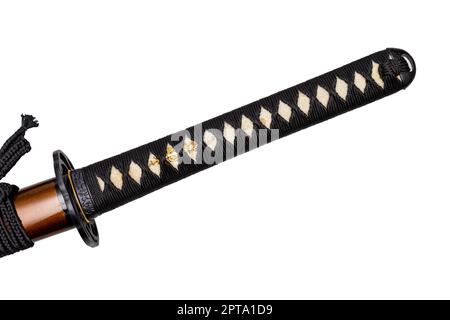 Tsuka - handle of Japanese sword wrapped by black silk cord on white ray skin isolated in white background. Selective focus. Stock Photo