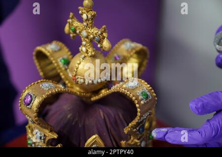 Dawn Jenks et Donna Oluban, chocolatiers du monde de Cadbury, ajoutent les touches finales à une réplique de 45cm grands chocolats de la couronne de St Edward à Cadbury World à Birmingham. Il a fallu deux jours pour construire leur version de la couronne qui sera utilisée au couronnement du roi Charles III en utilisant du chocolat blanc et du lait, et dépoussiéré avec des paillettes comestibles. Date de la photo: Mercredi 26 avril 2023. Banque D'Images