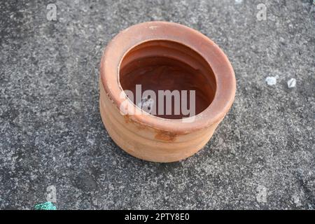 Tasse en argile ronde. Vue de dessus d'un bol en argile sur un fond de sol. Bols en argile sur sol en béton Banque D'Images