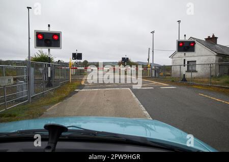 voiture en attente sur le passage à niveau de la voie ferrée avec barrière en bas du comté de la république de mayo en irlande Banque D'Images