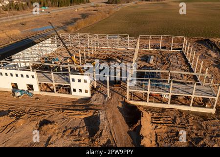 Photographie par drone d'un entrepôt construit par des ouvriers de la construction au cours de la matinée du printemps Banque D'Images