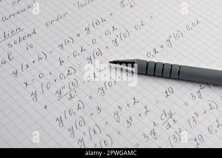 Papier avec calculs mathématiques écrits et stylo, gros plan Banque D'Images