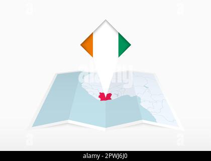 La Côte d'Ivoire est représentée sur une carte papier pliée et un marqueur de position épinglé avec drapeau de la Côte d'Ivoire. Carte vectorielle pliée. Illustration de Vecteur