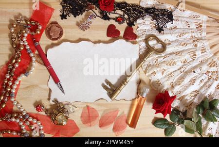Bijoux vintage et dentelle avec clé antique sur fond en bois avec papier vierge Banque D'Images