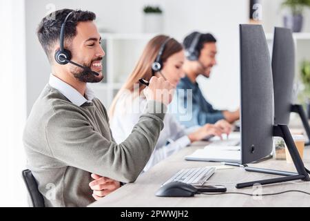 Résolution des problèmes un appel à la fois. un beau jeune homme agent de centre d'appels travaillant dans son bureau Banque D'Images