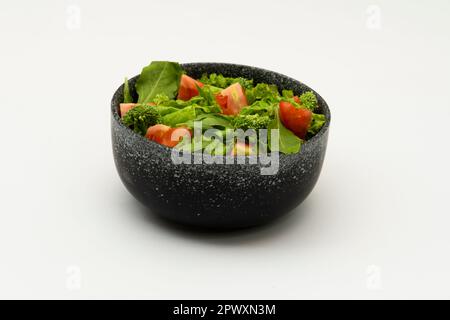 Salade végétalienne verte provenant de feuilles vertes et légumes sur fond blanc. Banque D'Images
