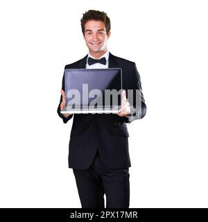 Suave dans les ventes. Un jeune homme tenant un ordinateur portable tout en portant un costume et un noeud papillon. Banque D'Images