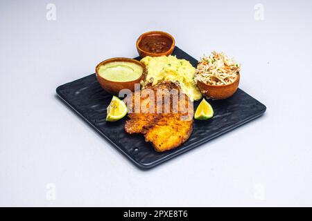 Un poulet émietté, une purée de pommes de terre crémeuse et des hors-d'œuvre isolés sur un fond blanc Banque D'Images