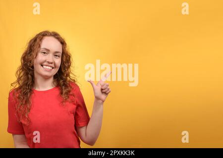 jeune jolie femme pointant vers la direction avec le doigt Banque D'Images