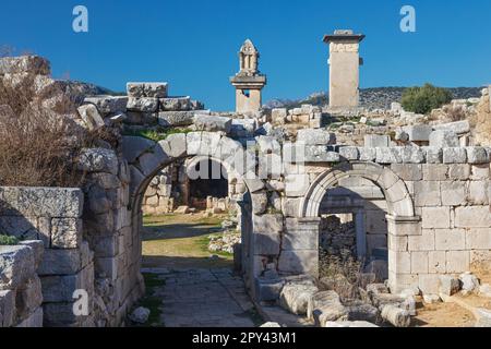 Porte d'entrée du théâtre de la ville antique de Xanthos - partie de la voie lycienne. Tombeau monument du roi Kybernis (Tombeau de Harpy), tombeau de pilier en arrière-plan. Banque D'Images