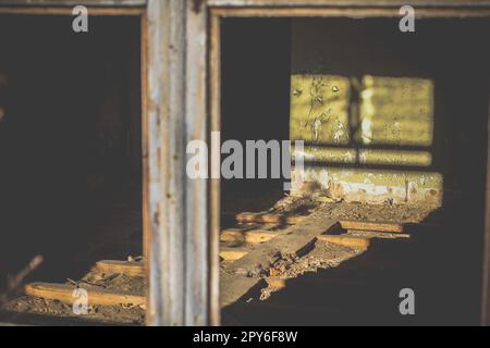 Gros plan de la lumière du soleil à travers une fenêtre cassée sur le mur avec une peinture vert écaillée photo concept Banque D'Images