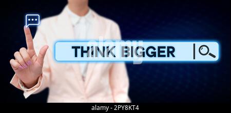 Écriture affichage du texte pensez plus grand. Mot pour pouvoir rêver et visualiser ce que vous pouvez réaliser Banque D'Images