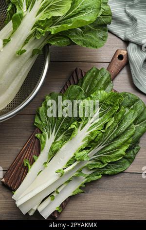 Chou blanc de chou vert frais avec gouttes d'eau sur une table en bois, plat Banque D'Images