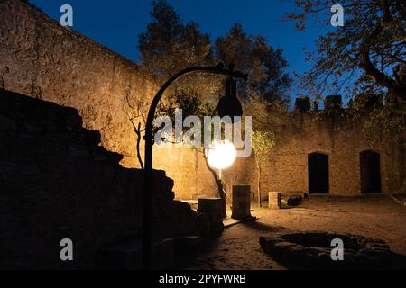 Ensemble de lumière avec abat-jour rond dans la nuit. Murs en pierre du château de San Jorge à Lisbonne, Portugal Banque D'Images