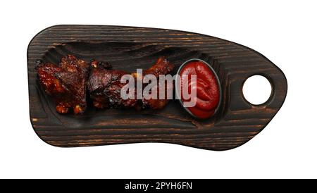 Côtes de rechange au barbecue et sauce barbecue sur bois Banque D'Images