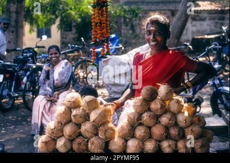 Une fille vendant des noix de coco devant un temple Vishakapatnam, Andhra Pradesh, Inde du Sud, Inde, Asie Banque D'Images