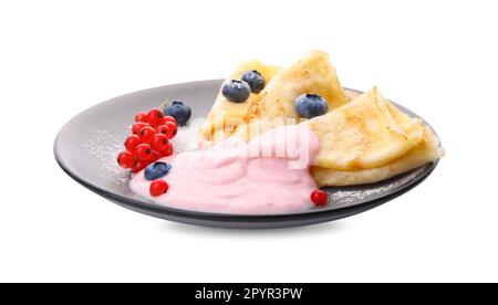 Délicieuses crêpes au yaourt naturel, aux myrtilles et aux raisins de Corinthe rouges sur fond blanc Banque D'Images