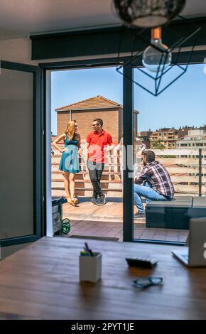 Vue des collègues qui parlent sur le toit à travers une porte de bureau de collègue Banque D'Images