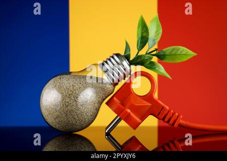 Bouchon, plante poussant à l'intérieur de l'ampoule et drapeau de Roumanie. Concept d'énergie renouvelable écologique. Banque D'Images