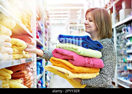 Une femme achète des serviettes au supermarché Banque D'Images