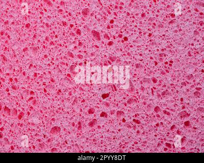 Texture rapprochée d'une éponge à laver. Arrière-plan abstrait rose Banque D'Images