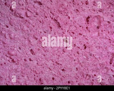 Texture rugueuse d'éponge rose. Arrière-plan abstrait en gros plan Banque D'Images