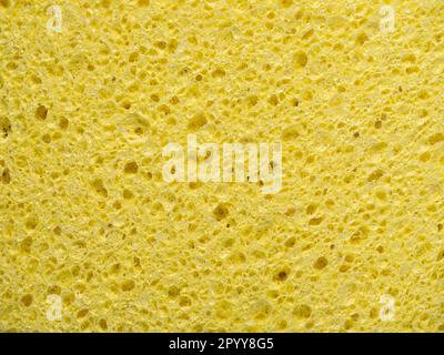 Arrière-plan abstrait avec texture de l'éponge de lavage jaune en gros plan Banque D'Images