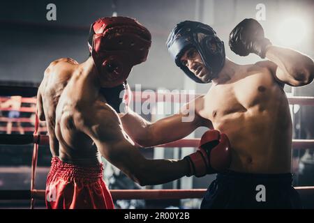 Boxer utiliser différentes combinaisons de poinçons, y compris le jab, crochet, coupe supérieure, croix, rotation, droite. Se rapprocher pour faire un adversaire sur les cordes et le knopo Banque D'Images