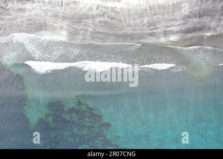 Vue aérienne du rivage dans les îles Féroé - turquoise et la mer verte rencontrant le sable avec la douce vague était Banque D'Images