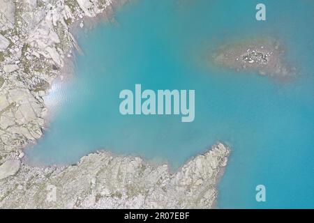 DefAbstract fragments aériens du Lago Vedretta, Val Nambrone – eaux turquoises glaciaires et texturesault de roches alpines Banque D'Images